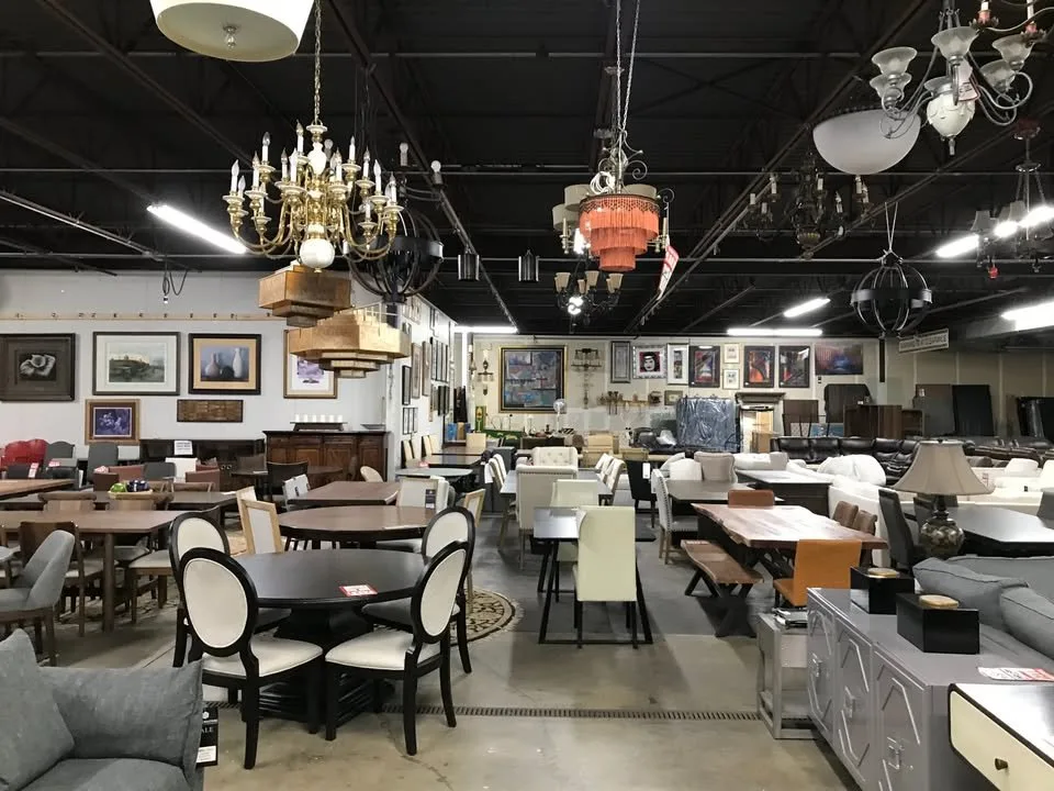 Dining tables, chairs, and brass chandeliers filling the floor at Unique Furniture Warehouse, Twin Cities furniture outlet