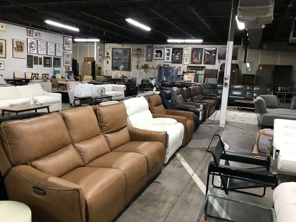 Rows of leather sofas and reclining loveseats on the floor at Unique Furniture Warehouse, a Twin Cities furniture outlet in Eden Prairie