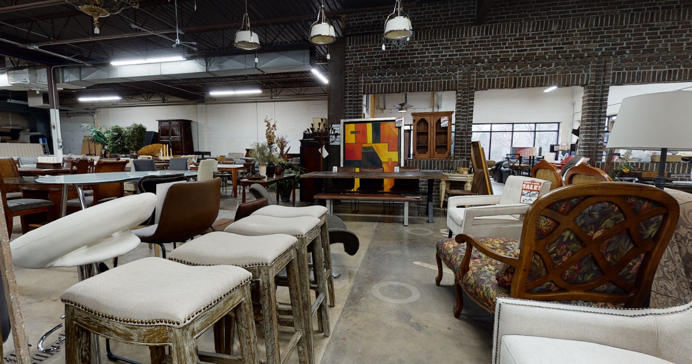 Bar stools and dining chairs beside a live-edge table under industrial lighting at Unique Furniture Warehouse, Twin Cities furniture outlet